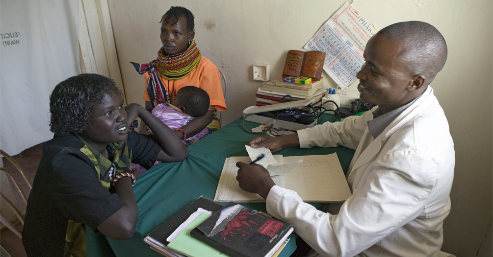 A doctor consults with mother and children about HIV/AIDS at Pepo La Tumaini Jangwani, HIV/AIDS Community Rehabilitation Program, Orphanage and Clinic. Nairobi, Kenya, Africa