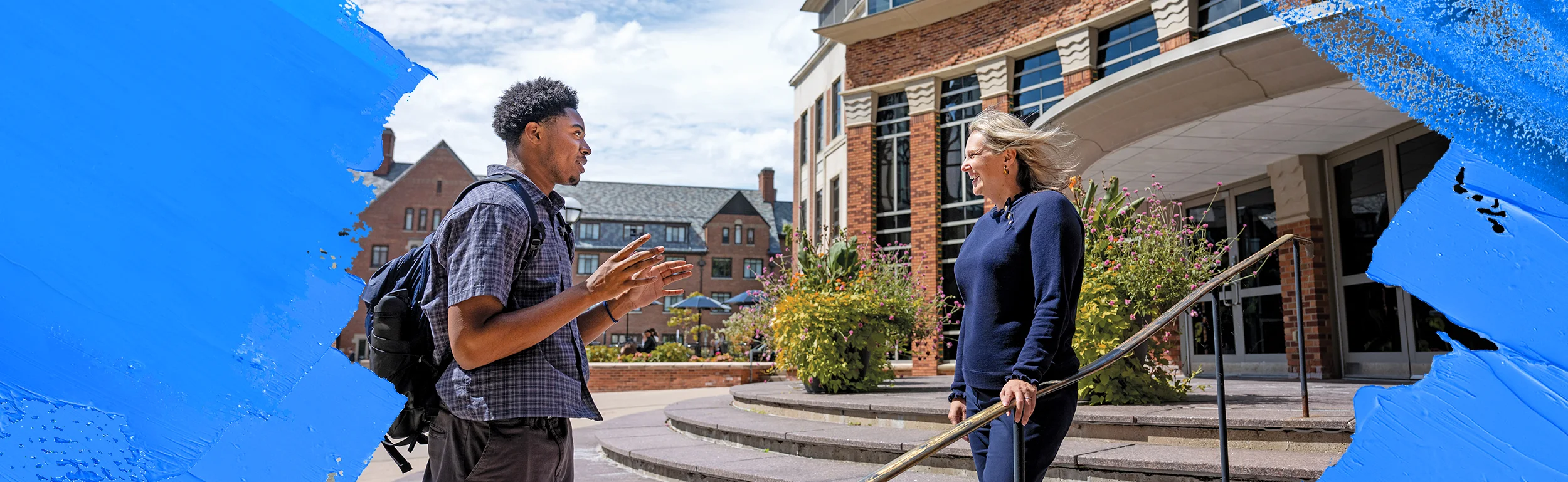A Michigan School of Public Health student speaks with faculty member Emily Youatt outside the school building on campus.
