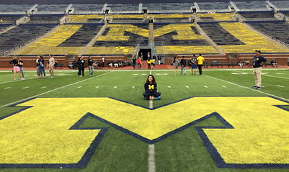 Student on the football field at the UM Big House