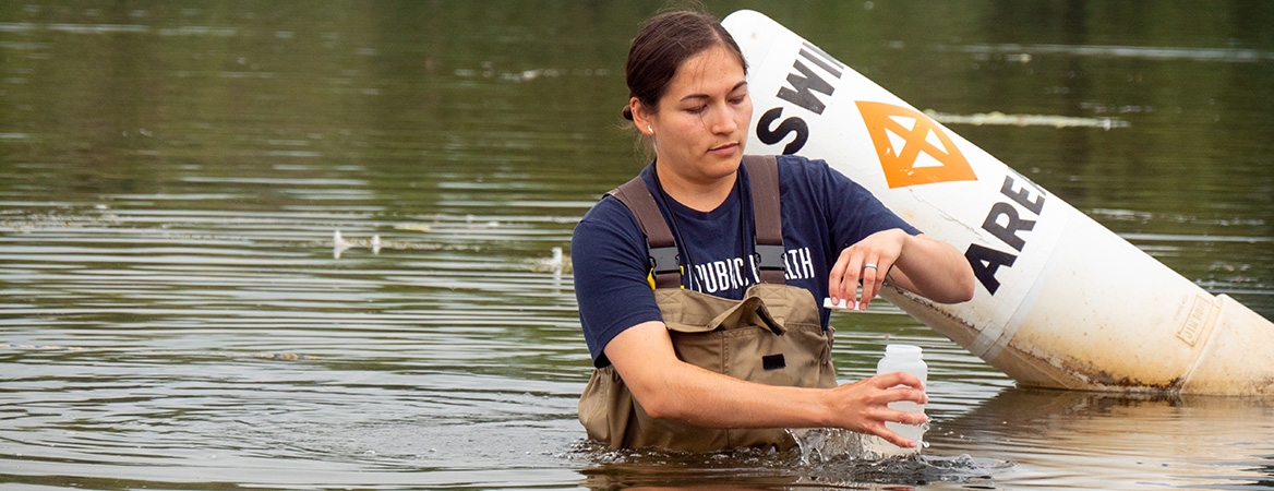 student collecting water samples as part of her internship