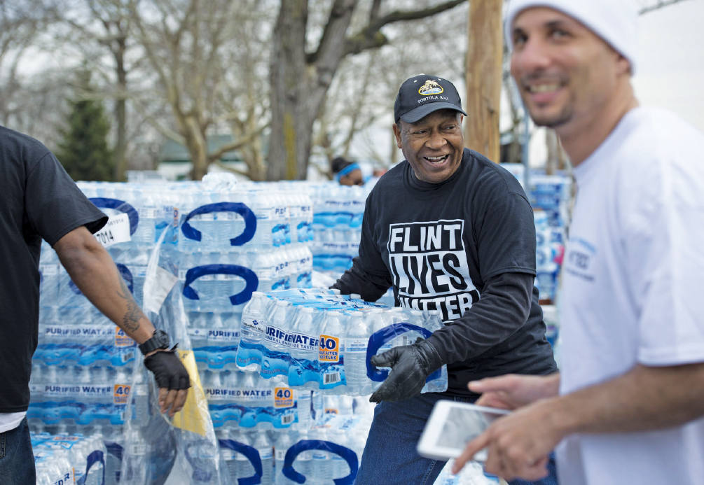 Volunteers distribute cases of water in Flint on March 12, 2016.