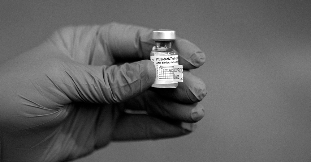 Hand holding a vial of Pfizer-BioNTech COVID-19 vaccine at Michigan Medicine