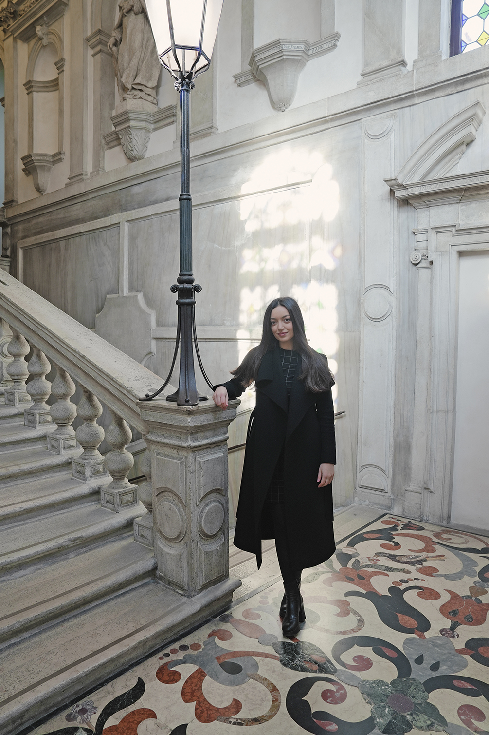 Inside the hospital, Jasmina Cunmulaj stands next to the staircase that leads to her former office.