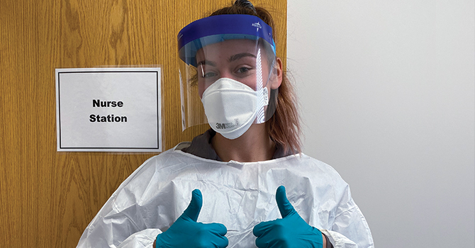 Camile Molina, MPH ’20, in full PPE as she volunteers with the Detroit Health Department in its COVID-19 testing clinic for city employees