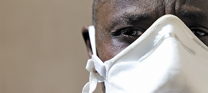 Closeup of an individual of African descent wearing a mask