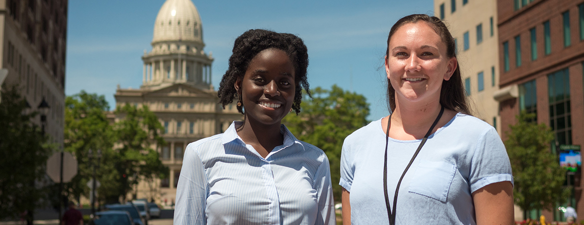 Interns standing in front of the Lansing capitol building