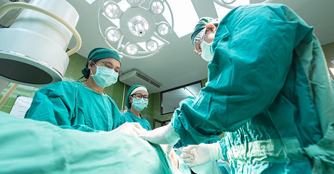 Surgeons operating on a patient