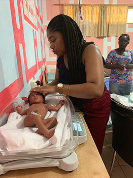 Janae Best working on her project "Examining the Prevalence of Traditional Medicine Usage Among Mothers with Low Birth Weight and Premature Infants".