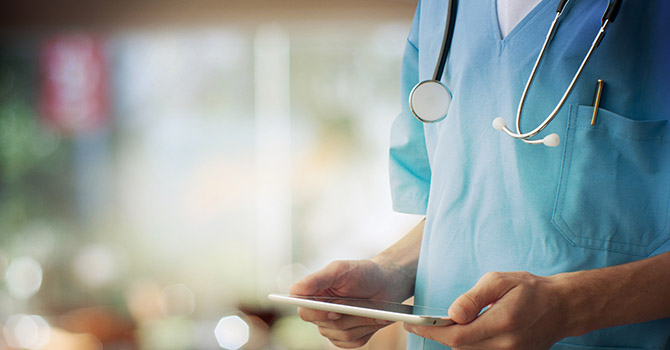 Medical professional holding a tablet