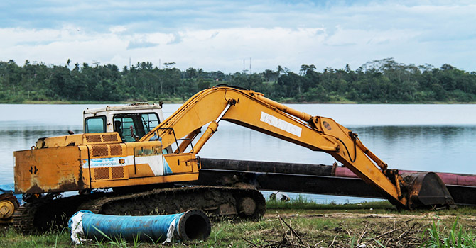 Excavator dredging a river