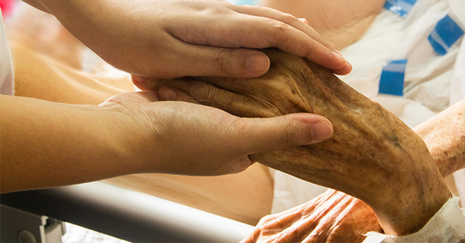 elderly person in care of medical staff