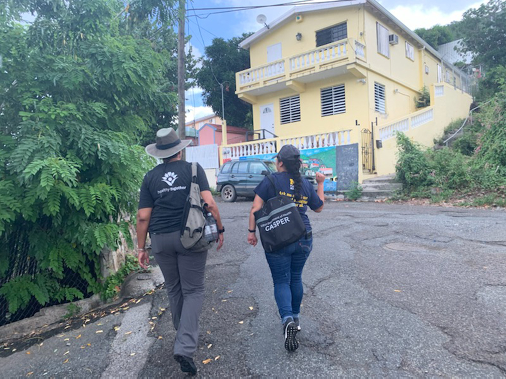 Cindra James of Washtenaw County Health Department and Quetzabel Benavides out in field surveying cluster in St. Thomas