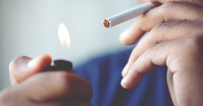 Male lighting a cigarette