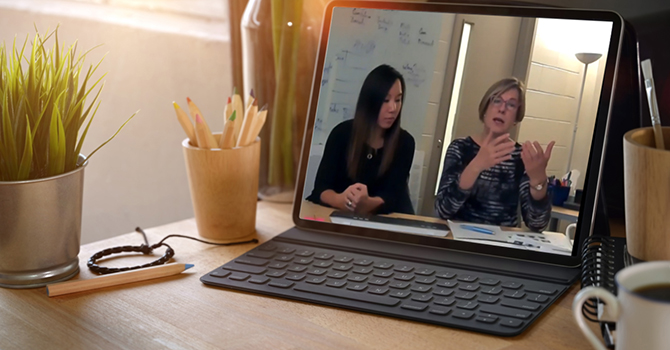 Faculty teaching a class online via computer.