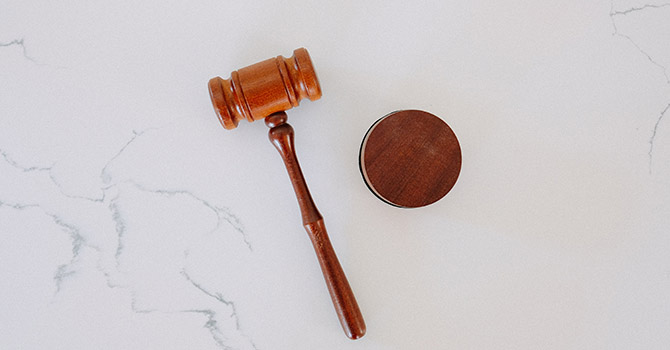 Wooden gavel on a marble table.