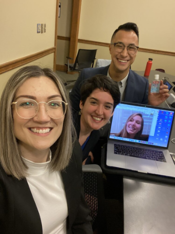 Michigan Public Health student Anthony Dang and his teammates Julia Dinoto (School of Information), Elisabeth Fellowes (School of Information), and Anne Fitzpatrick (College of Literature, Science, and the Arts) pose for a picture during a meeting.