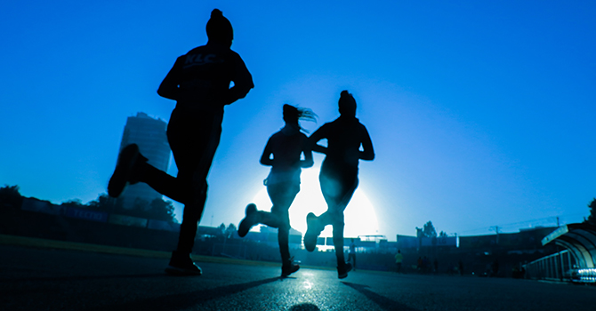 Three women running.