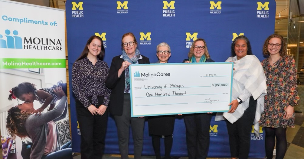 Members of U-M are presented a check from The MolinaCares Accord team.