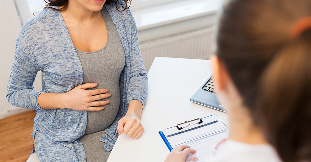 A pregnant woman speaking with her doctor