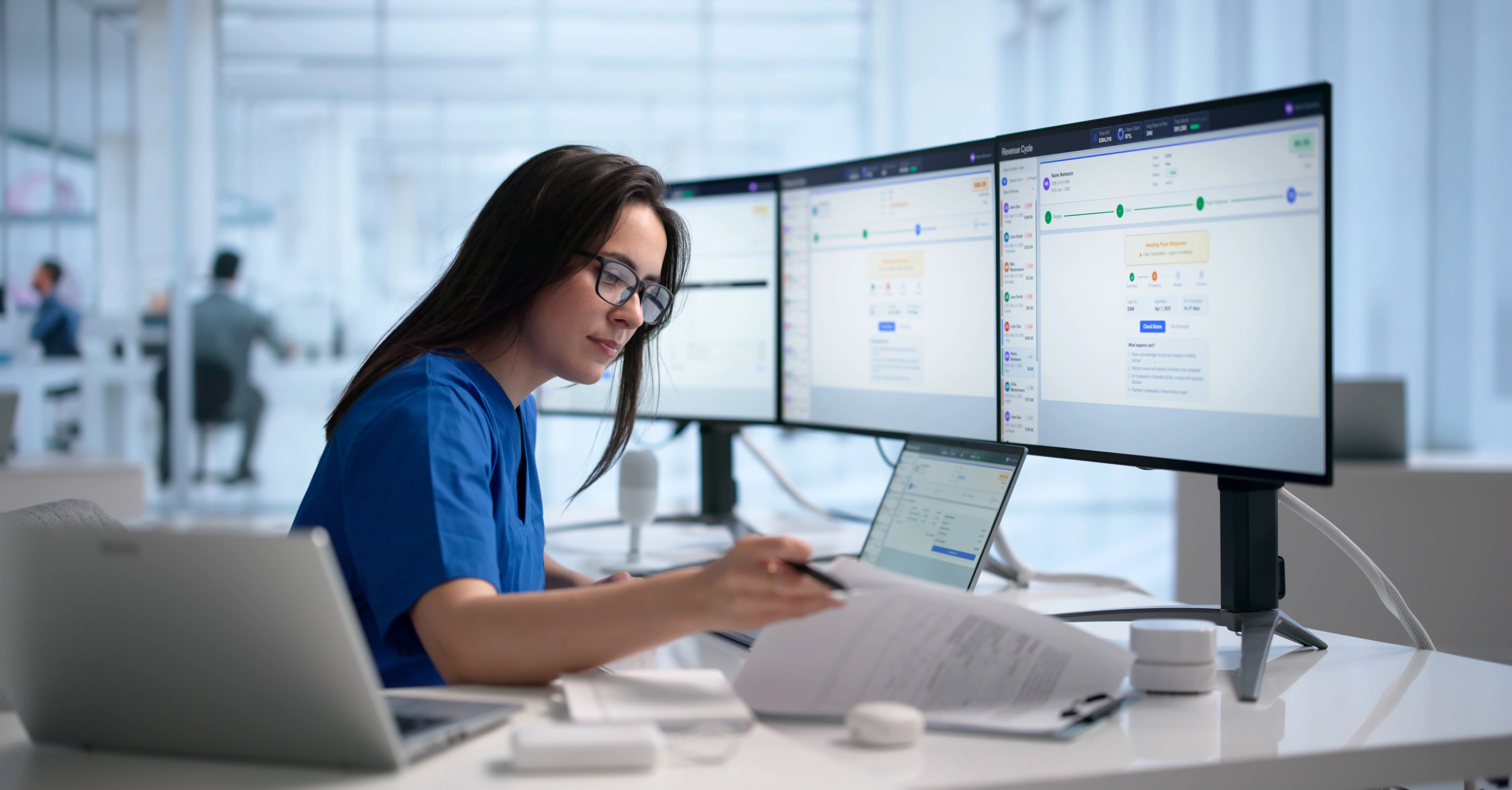 A woman working at a computer in a healthcare facility. 
