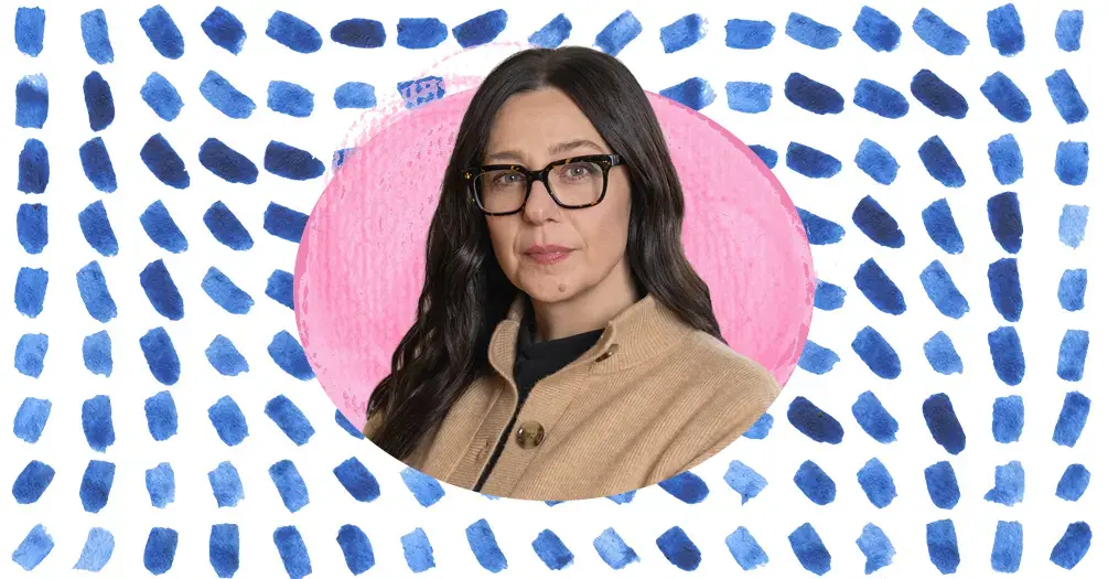 Kendrin Sonneville headshot, framed within an light pink oval on a white and blue patterned background.