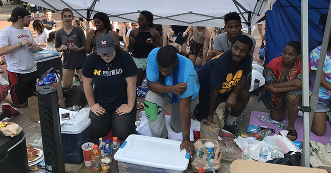 Dana Greene kneeling on the Diag