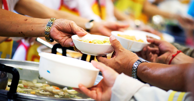 Volunteers and professionals distribute food to those affected by a crisis