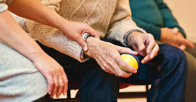 Elderly person holding stress ball