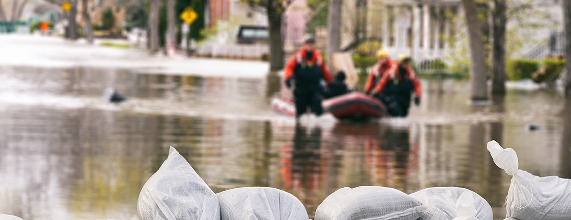 Disaster relief workers moving through a flooded street