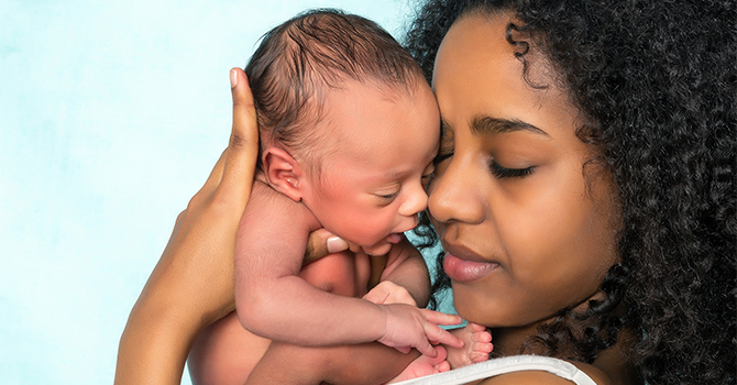 Black Mother holding a newborn baby