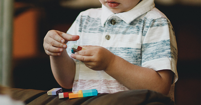 a child works on development puzzles