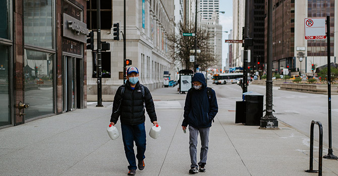 People walking in a city with masks on.