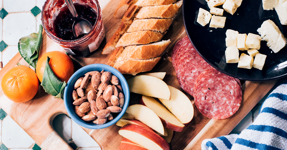 Table spread with nuts, fruit, bread, meat, cheese