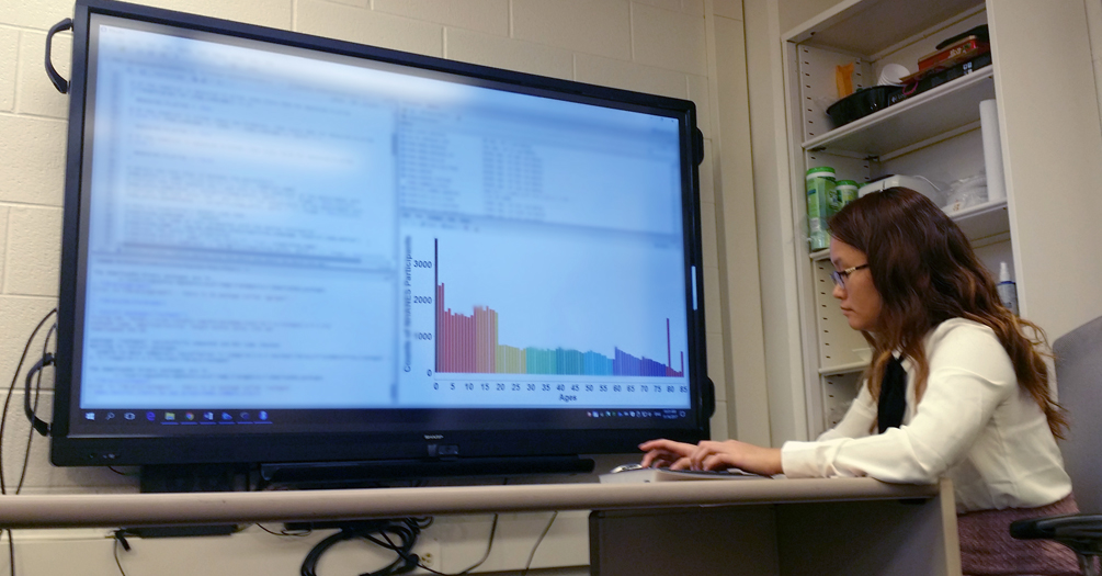 A student uses technology and digital connections to review public health data at the University of Michigan School of Public Health