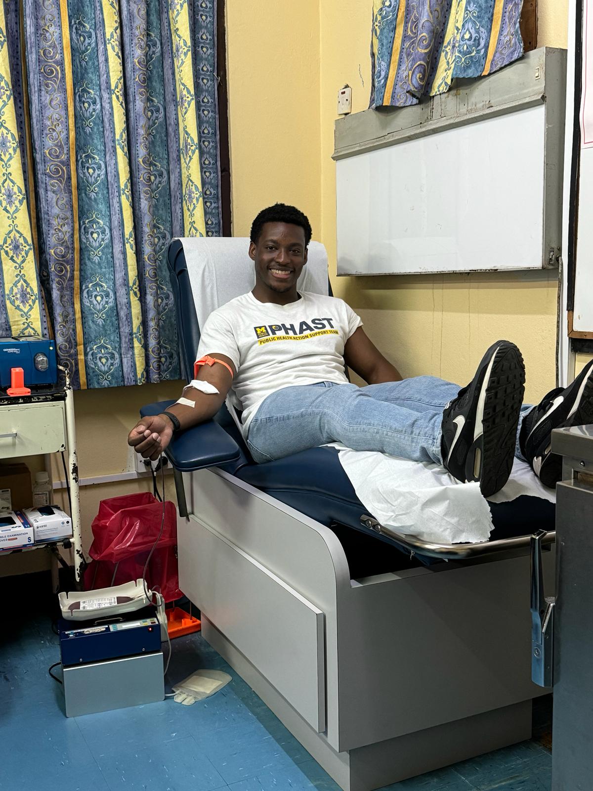 Caption: Darius Moore donating blood at the BBG