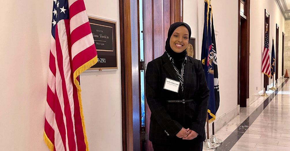 Farhia Ahmed Mohamed stands in front of Senator Elissa Slotkin's office in Washington, DC.