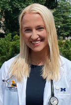 Photo of Ellie Falahee in a white medical coat