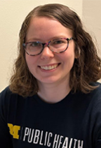 Alicia Even, wearing a blue t-shirt that has the logo of the University of Michigan School of Public Health 