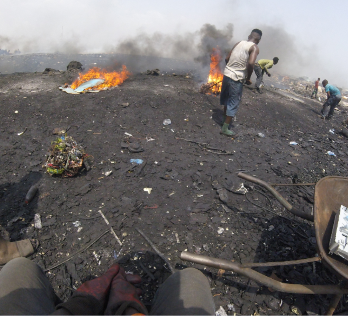 Workers burn e-waste to recover valuable metals.