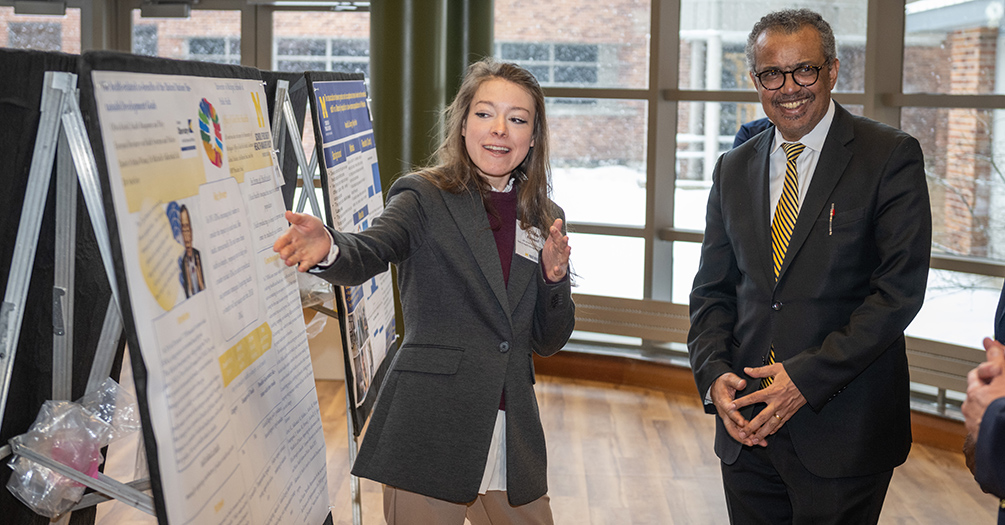 Olivia Rockwell presents her poster to Dr. Tedros Adhanom Ghebreyesus, director-general of the World Health Organization