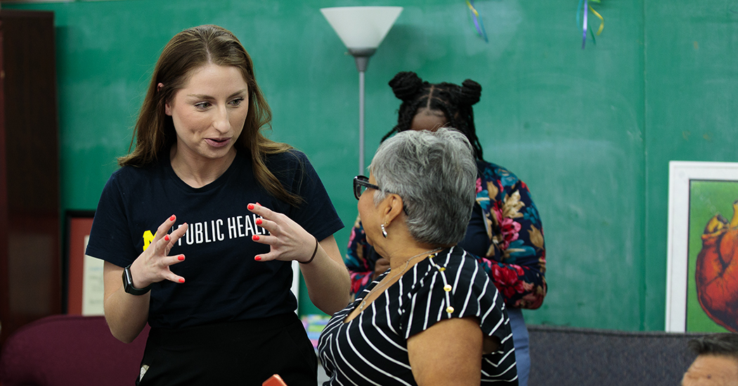 Lauren Czarnowczan, left, talks to a San Antonio community member